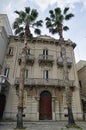 Small square of Bari city, with green palms in front of old tenement, Puglia Apulia region, Southern