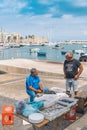 Local fishermen washing, cleaning and selling fresh raw sea fruits Royalty Free Stock Photo