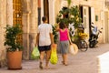 BARI, ITALY - JULY 11, 2018, a man and a woman come back with purchases, a scene from everyday life on the street of old Bari,