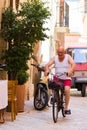 BARI, ITALY - JULY 11, 2018, Scenes from the life of centre of Bari: one old man riding a bicycle Royalty Free Stock Photo