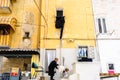 Bari, Italy - March 10, 2019: Elderly woman cleaning the portal of her house, concept of female work Royalty Free Stock Photo