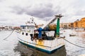 Bari, Italy - March 12, 2019: Old fishing boats moored to port dirty and in disuse Royalty Free Stock Photo