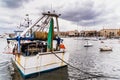 Bari, Italy - March 12, 2019: Old fishing boats moored to port dirty and in disuse Royalty Free Stock Photo