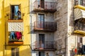 Bari, Italy - March 10, 2019: Older woman leaning on the balcony of her colorful house