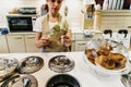 Bari, Italy - March 10, 2019: Waitress in a gelateria ice cream shop preparing an ice cream in waffle