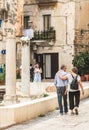 Couple of tourists walking among the remains and columns of a Roman Temple in Bari old town