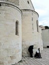 Person praying under the walls of the Vallisa Church