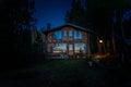 BARILOCHE, ARGENTINA, JUNE 19, 2019: Exterior of a wooden cozy and relaxing cabin in the forest during the last moments Royalty Free Stock Photo