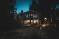 BARILOCHE, ARGENTINA, JUNE 19, 2019: Exterior of a wooden cozy and relaxing cabin in the forest during the last moments of light Royalty Free Stock Photo