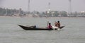 Barisal, Bangladesh, March 12, 2023, Rural fishermen on a small wooden boat. Kids catching fish on a small dinghy floating on a