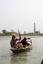 Barisal, Bangladesh, March 12, 2023, Rural old sailor on a small wooden boat. Old sailor with a woman on a small dinghy floating