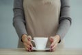 Barista in apron in coffee shop give just brewed fresh coffee to customer