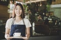 Barista asian women hands holding fresh coffee or latte art in white cup at coffee shop.