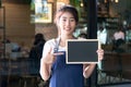 Barista asian women holding label Coffee order in the coffee shop.