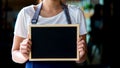 Barista asian women holding label Coffee order in the coffee shop. Royalty Free Stock Photo