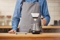 Barista at bar counter about to make pourover coffee. Royalty Free Stock Photo