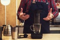 Barista brewing aeropress coffee