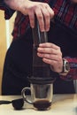 Barista brewing aeropress coffee