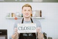 Barista cafe coffee staff hand holding shop Closed sign banner, Restaurant Close or reclosed from Covid-19 lockdown concept Royalty Free Stock Photo