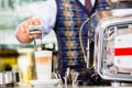 Barista in cafe pouring espresso shot in latte macchiato Royalty Free Stock Photo