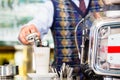 Barista in cafe pouring espresso shot in latte macchiato Royalty Free Stock Photo