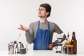 Barista, cafe worker and bartender concept. Confused young serious-looking guy working in restaurant, cafeteria Royalty Free Stock Photo