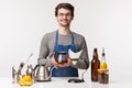 Barista, cafe worker and bartender concept. Friendly cheerful young guy employee in store wearing apron, holding filter Royalty Free Stock Photo