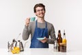 Barista, cafe worker and bartender concept. Portrait of friendly young smiling male employee working in coffee store Royalty Free Stock Photo