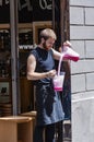 Barista carefully pours liquid from one container to another one