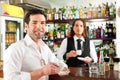 Barista with client in his cafe or coffeeshop