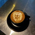 Barista coffee latte art on black pirch cup Royalty Free Stock Photo