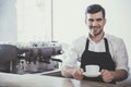 Barista with cup of coffee in his hands. Royalty Free Stock Photo