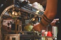 Barista on espresso machine making fresh coffee. Barman at work in a restaurant or cafe Royalty Free Stock Photo