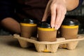 Barista girl holding paper cups for hot drinks. coffee to go. Royalty Free Stock Photo