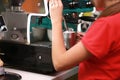 Barista girl prepares coffee on the coffee machine Royalty Free Stock Photo