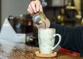 Barista girl prepares delicious aromatic coffee for coffee shop guests Royalty Free Stock Photo