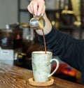 Barista girl prepares delicious aromatic coffee for coffee shop guests Royalty Free Stock Photo