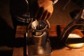 Barista grinding coffee beans, Manual coffee grinder