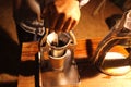 Barista grinding coffee beans, Manual coffee grinder