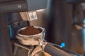 Barista grinding coffee ready for perfect cup of espresso