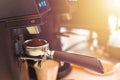 Barista grinding coffee ready for perfect cup of espresso in coffee shop