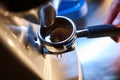 Barista grinding freshly roasted beans in coffee shop