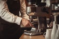 Barista hand and espresso pouring in a cup in a cafe shop. Coffee maker machine closeup, professional portafilter. Generative AI