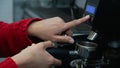 barista hand starting the grinder to begin the coffee grinding process Royalty Free Stock Photo