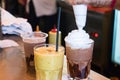 Barista hands pouring cold chantilly cream on a chocolate smoothy on a counter inside a coffee shop Royalty Free Stock Photo