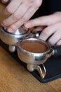 Barista hands temping coffee grind in espresso holder Royalty Free Stock Photo