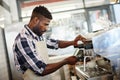 Barista at his best. Shot of a handsome male barista making a cup of coffee using an espresso machine. Royalty Free Stock Photo