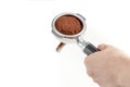 Barista hold the portafilter with coffee ground, prepare to tamp Royalty Free Stock Photo