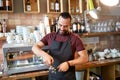 Barista with holder and tamper making at coffee