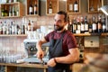 Barista with holder and tamper making at coffee